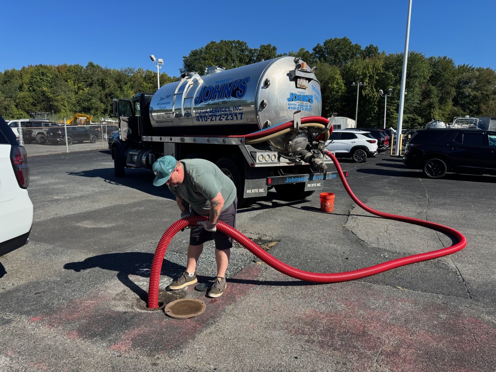 Septic tank pumping truck and crew on site